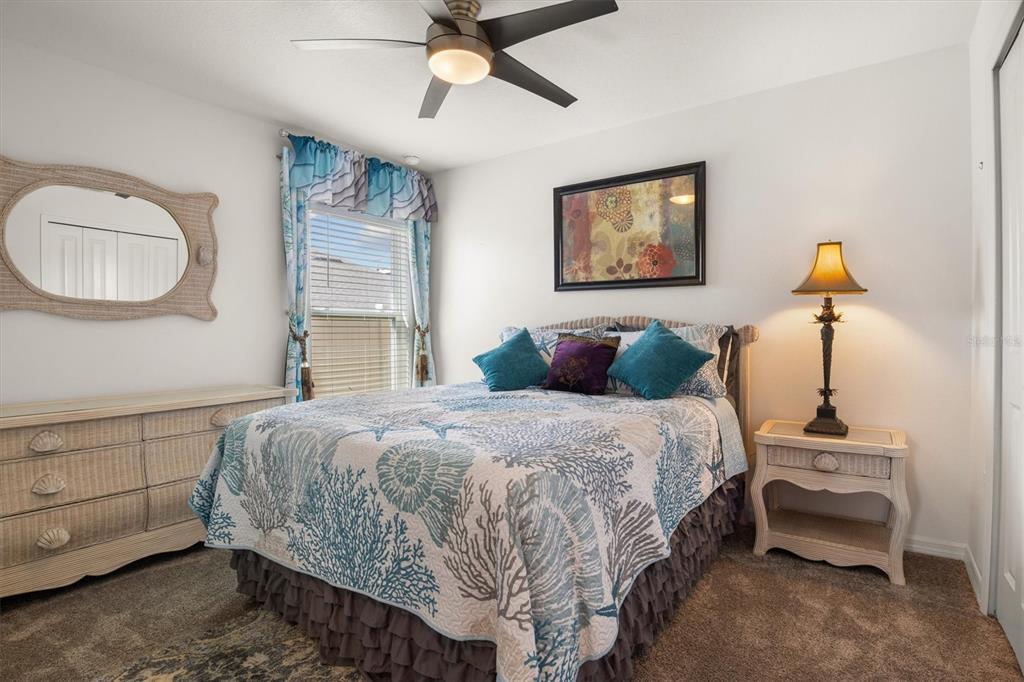 287 Inman Boulevard Winter Haven, FL 33881 - Photo 3 of 36 a bedroom with a bed and a chandelier