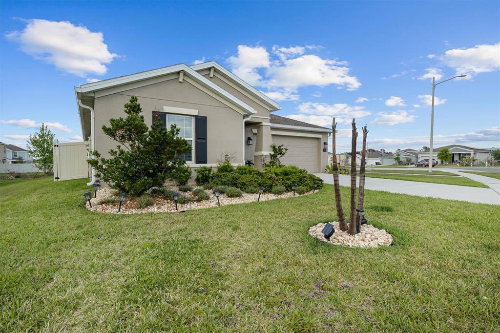 287 Inman Boulevard Winter Haven, FL 33881 - Photo 33 of 36 a view of a house with a yard and a fountain
