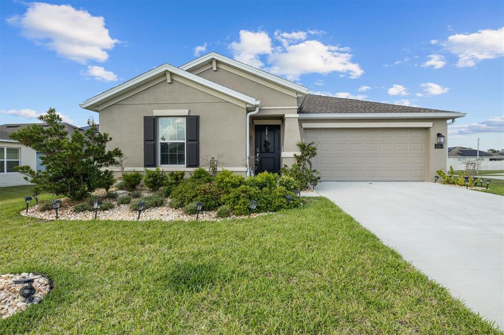 287 Inman Boulevard Winter Haven, FL 33881 - Photo 35 of 36 a front view of a house with a yard and garage