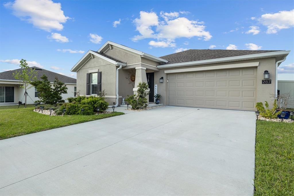 287 Inman Boulevard Winter Haven, FL 33881 - Photo 36 of 36 a front view of a house with a yard and garage