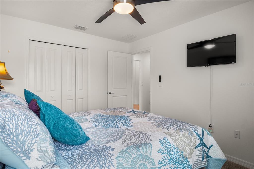 287 Inman Boulevard Winter Haven, FL 33881 - Photo 4 of 36 a bedroom with a bed and a flat screen tv