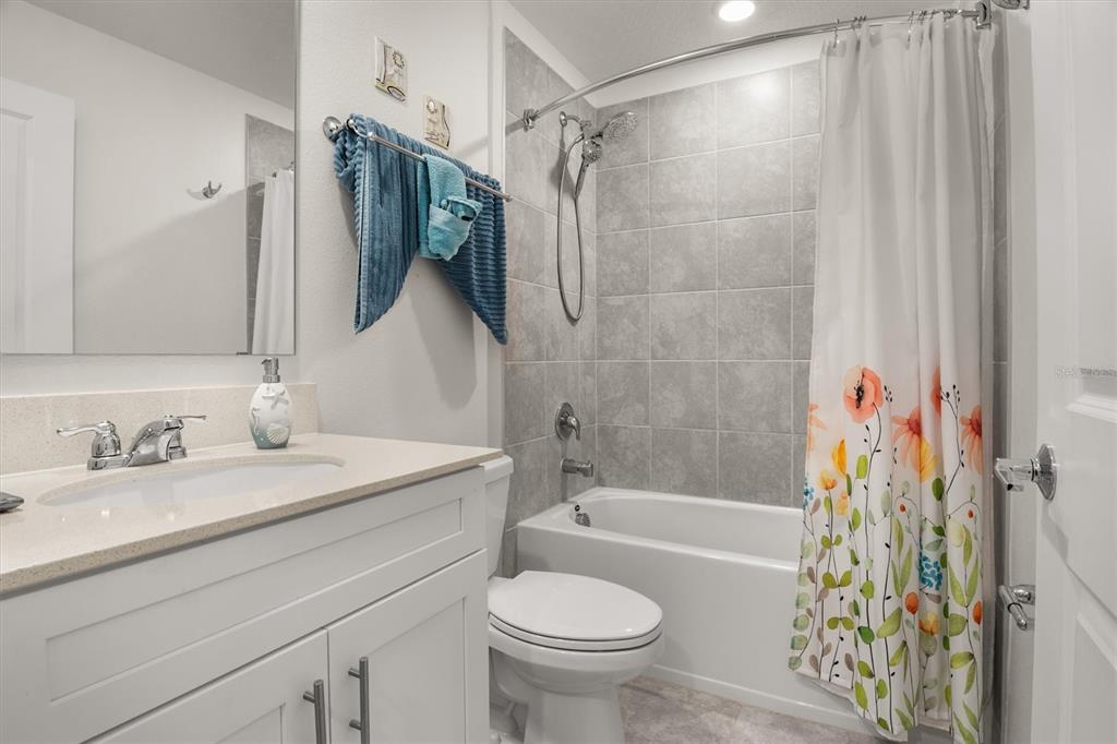 287 Inman Boulevard Winter Haven, FL 33881 - Photo 5 of 36 a bathroom with a sink toilet and shower