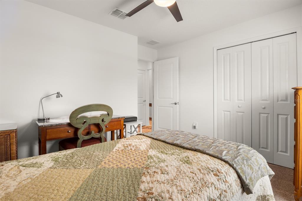 287 Inman Boulevard Winter Haven, FL 33881 - Photo 7 of 36 a bedroom with a bed and a chandelier