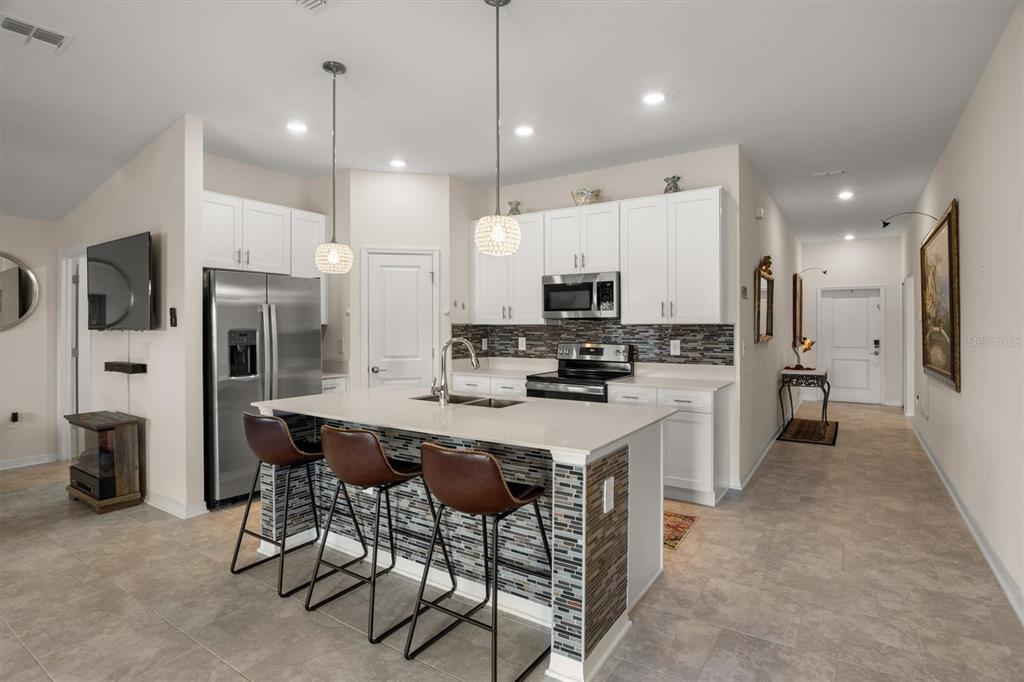 287 Inman Boulevard Winter Haven, FL 33881 - Photo 9 of 36 a kitchen with kitchen island appliances cabinets and furniture