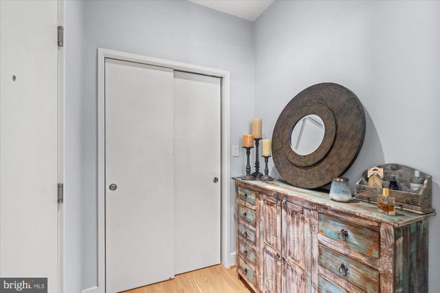 a room with lots of wooden furniture a sink a window and a couch