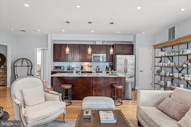 a living room with fireplace furniture and a flat screen tv