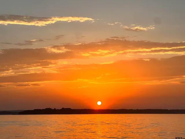 a view of a terrace with wooden floor and lake view