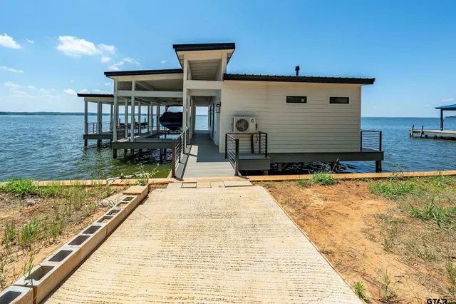 a view of a house with pool and sitting area