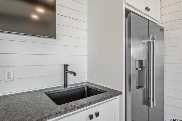 a kitchen with a sink and refrigerator
