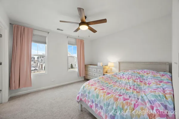 a bedroom with a bed and a book shelf