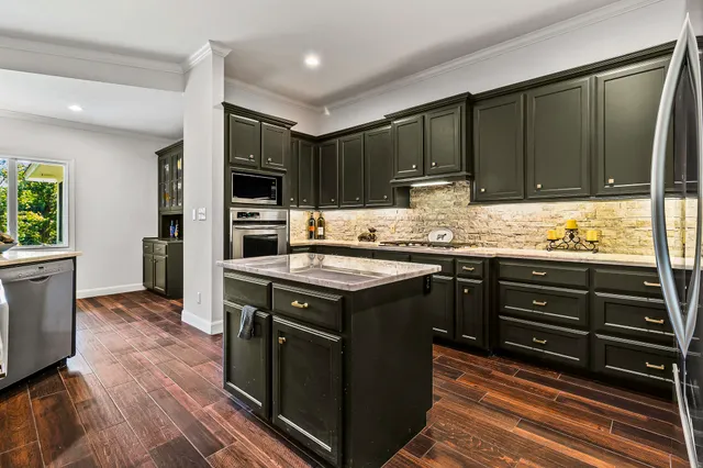 a kitchen with wooden cabinets and a stove top oven