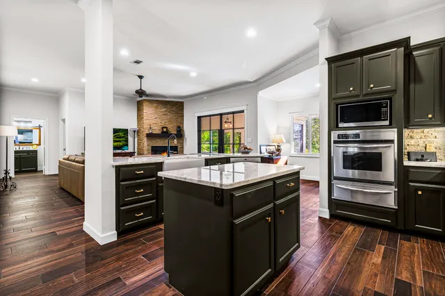 a kitchen with stainless steel appliances granite countertop a stove and a refrigerator
