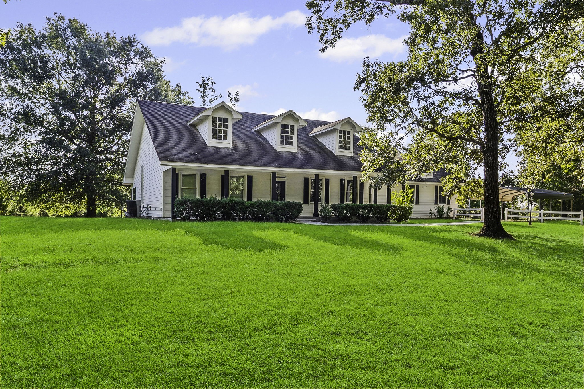 1387 Barrett's Landing Road Trinity, TX 75862 - Photo 2 of 50 a front view of a house with a garden