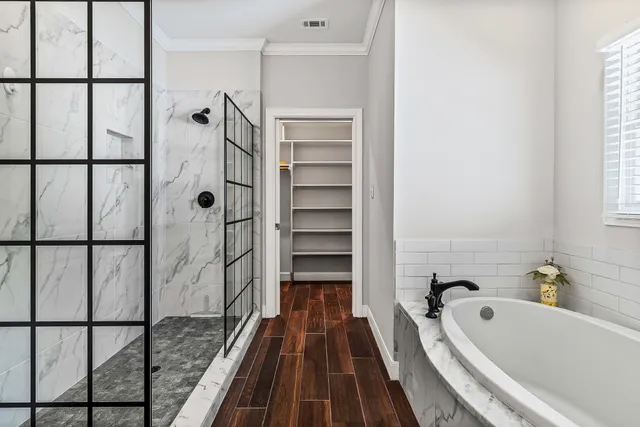 a bathroom with a bathtub and a shower
