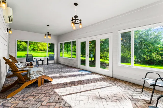 a view of a patio with a table chairs and a backyard