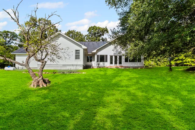 a view of a house with a yard and sitting area