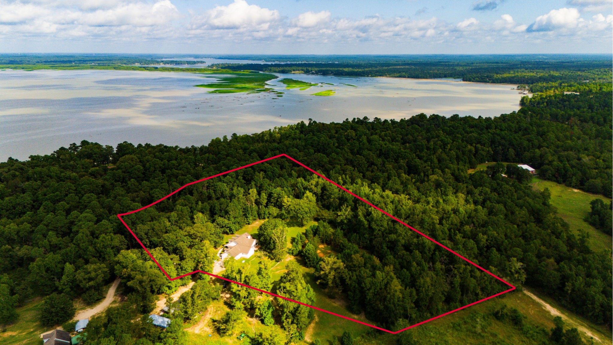 1387 Barrett's Landing Road Trinity, TX 75862 - Photo 50 of 50 a view of a lake with a big yard