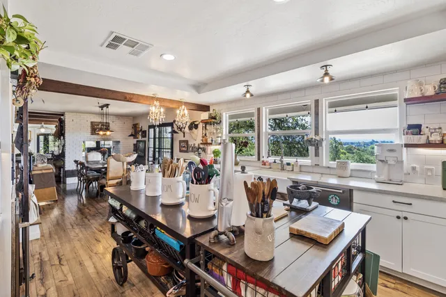 a living room with furniture and a painting on the wall