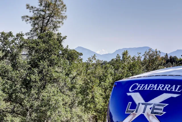 a view of a yard with wooden fence