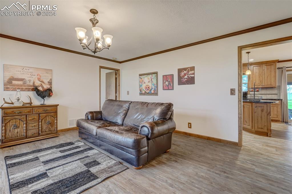21445 Scott Road Calhan, CO 80808 - Photo 16 of 50 a living room with furniture and a chandelier