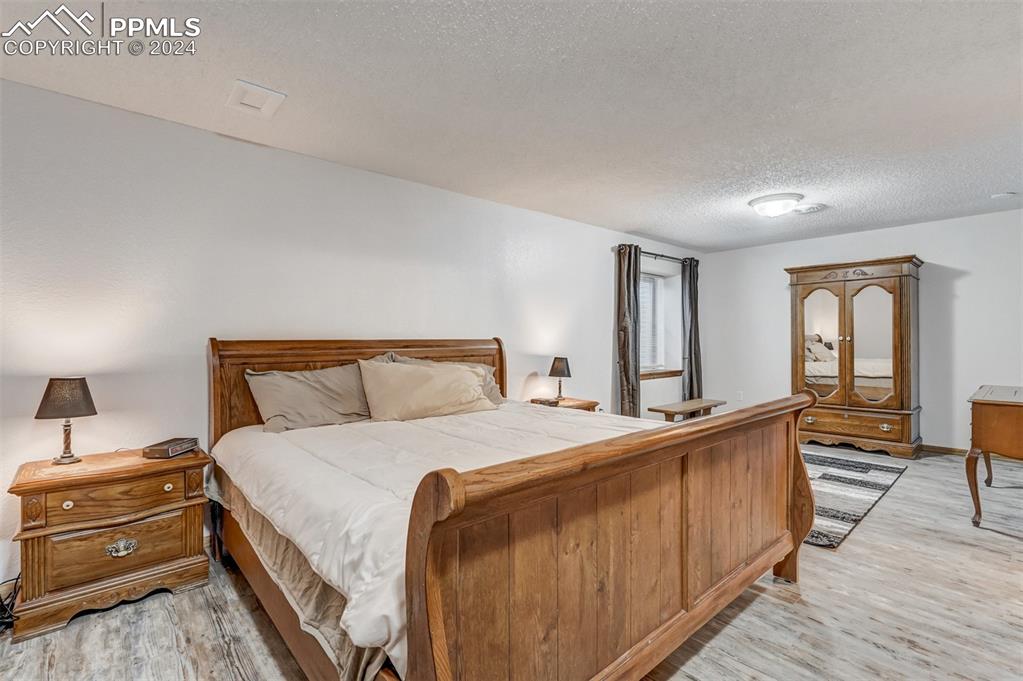 21445 Scott Road Calhan, CO 80808 - Photo 33 of 50 a bedroom with a bed and wooden floor