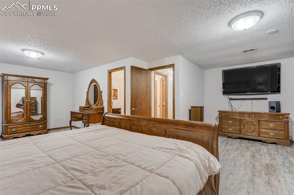 21445 Scott Road Calhan, CO 80808 - Photo 34 of 50 a bedroom with a bed and a flat screen tv