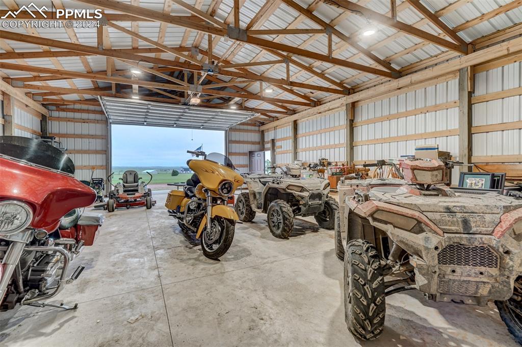 21445 Scott Road Calhan, CO 80808 - Photo 44 of 50 a view of a garage with a bike and a car