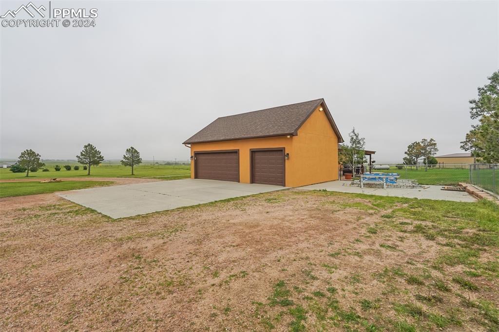 21445 Scott Road Calhan, CO 80808 - Photo 50 of 50 a view of yellow house with a yard and sitting space