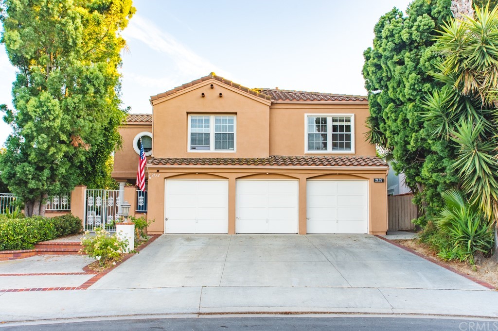 2132 Burnt Mill Road Tustin, CA 92782 - Photo 1 of 21 a front view of a house with a yard and garage