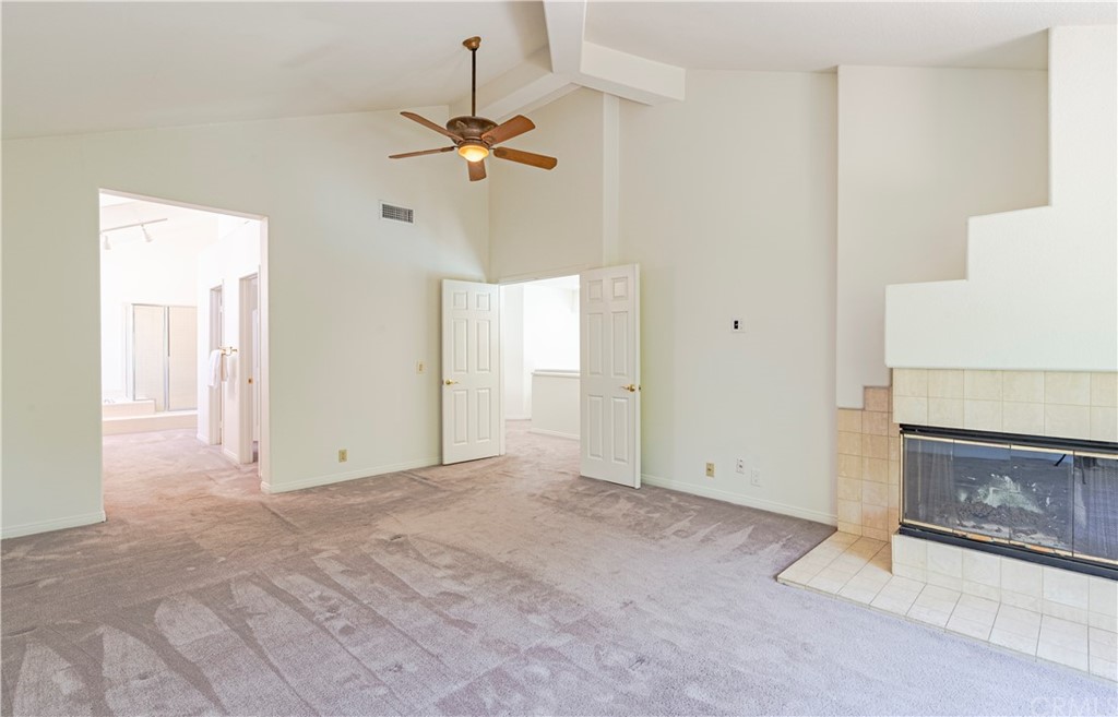 2132 Burnt Mill Road Tustin, CA 92782 - Photo 10 of 21 a view of an empty room with chandelier fan and fire place