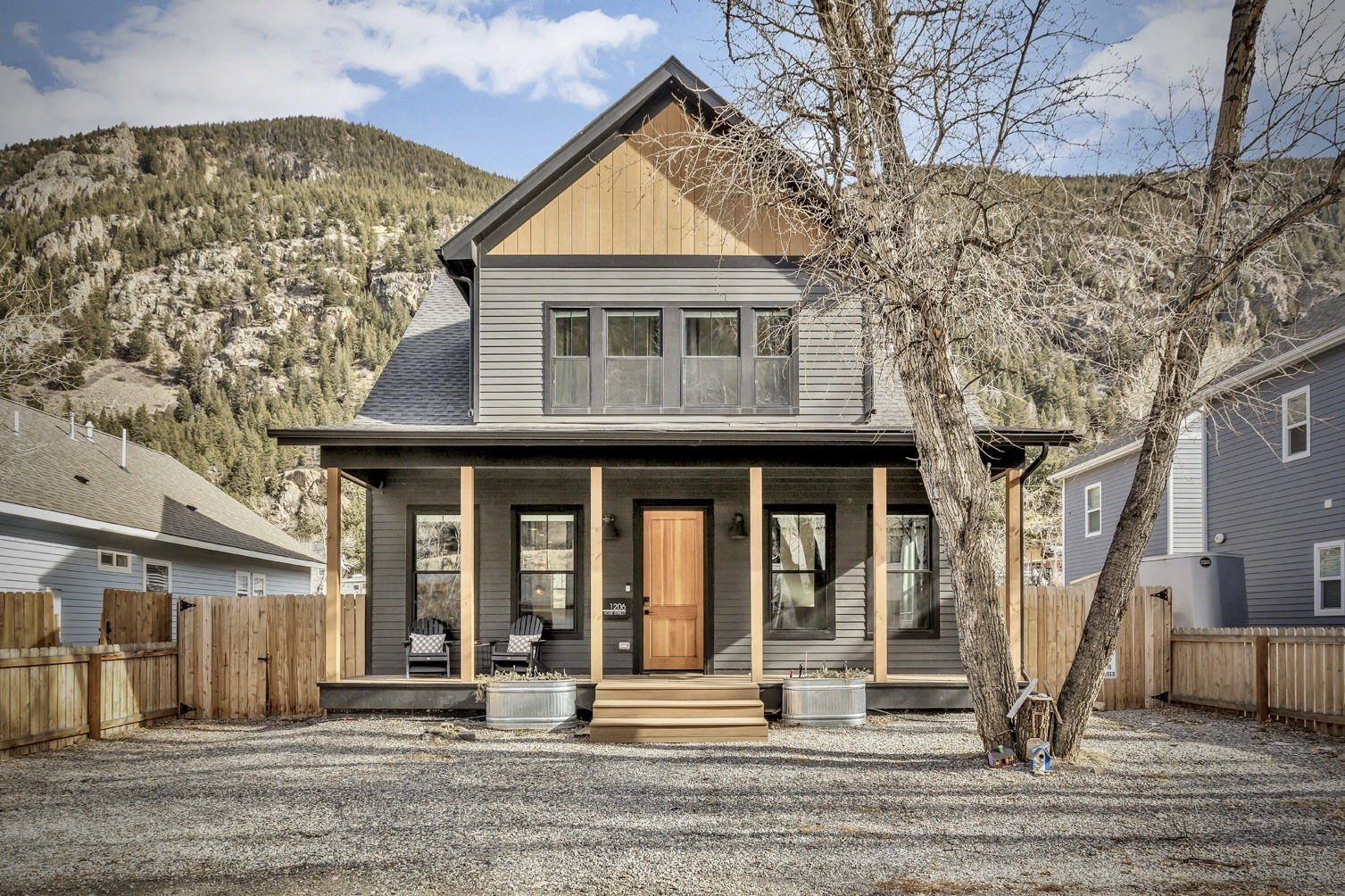 View of front of home with a porch, a mountain view, and a shingled roof