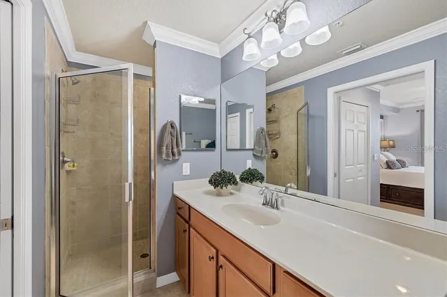 a bathroom with a sink vanity granite shower and a mirror