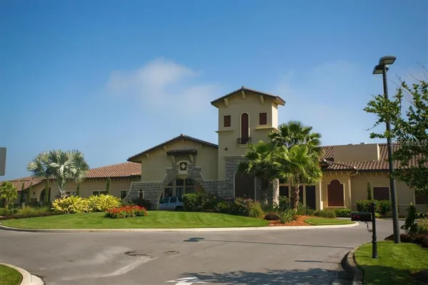 a front view of a house with a yard and potted plants