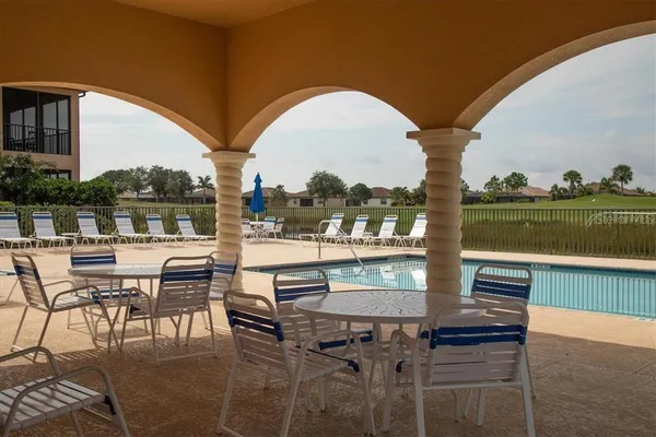 a view of a chairs and table in patio