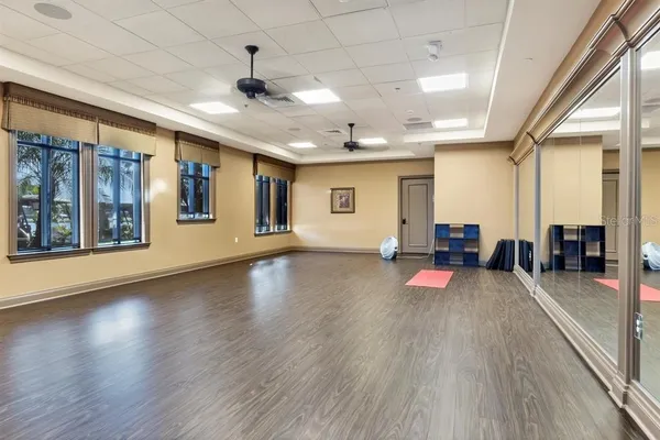 an empty room with wooden floor and furniture