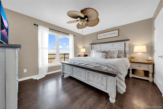 a bedroom with a large bed and a large window