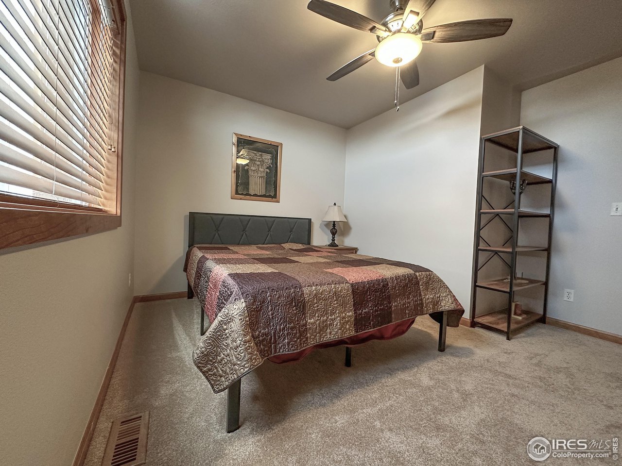 4491 Wellington Road Boulder, CO 80301 - Photo 11 of 40 a bedroom with a bed and a ceiling fan