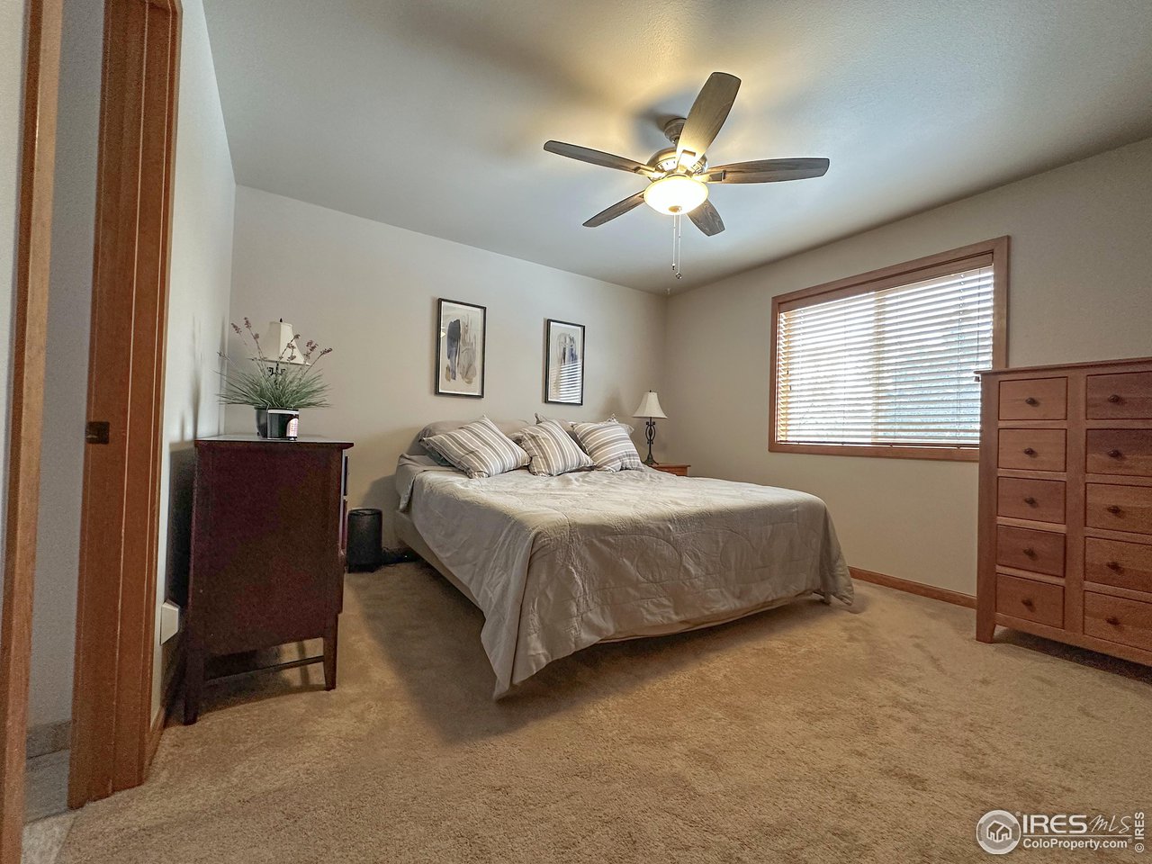 4491 Wellington Road Boulder, CO 80301 - Photo 14 of 40 a bedroom with a bed and a chandelier