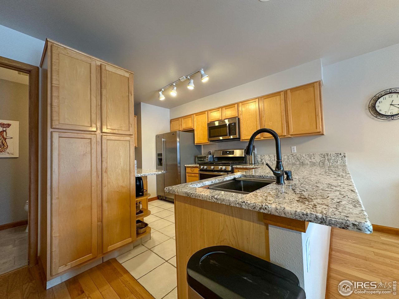 4491 Wellington Road Boulder, CO 80301 - Photo 4 of 40 a kitchen that has a sink a refrigerator and a stove top oven