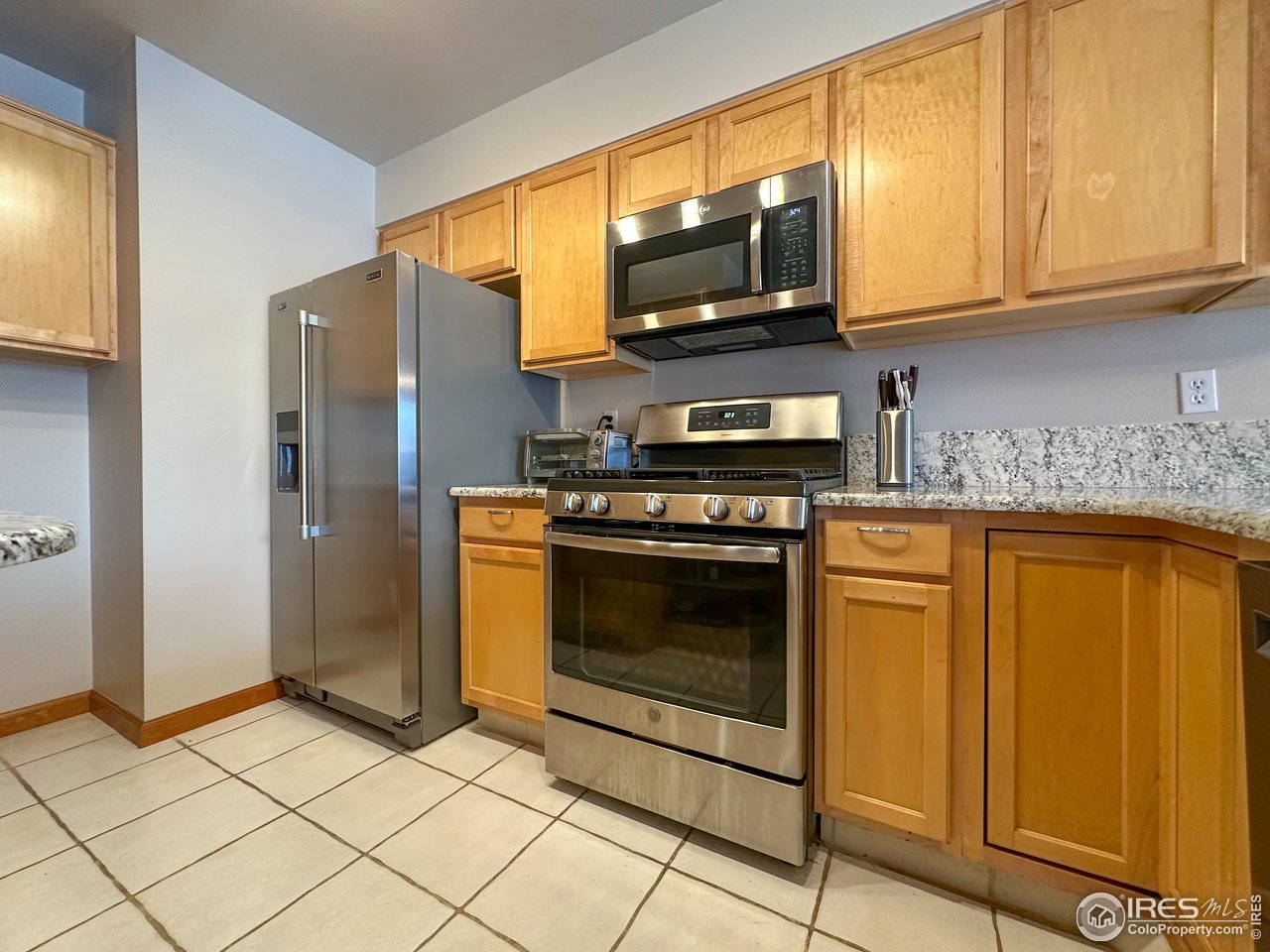 4491 Wellington Road Boulder, CO 80301 - Photo 5 of 40 a kitchen with stainless steel appliances granite countertop a refrigerator stove and microwave