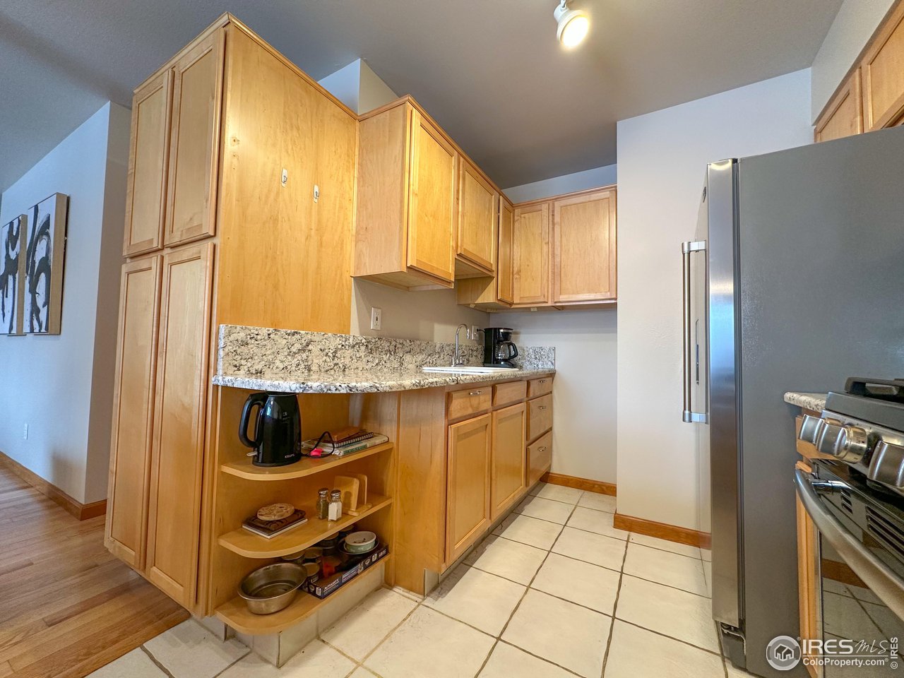 4491 Wellington Road Boulder, CO 80301 - Photo 6 of 40 a kitchen with a refrigerator a stove top oven and cabinets