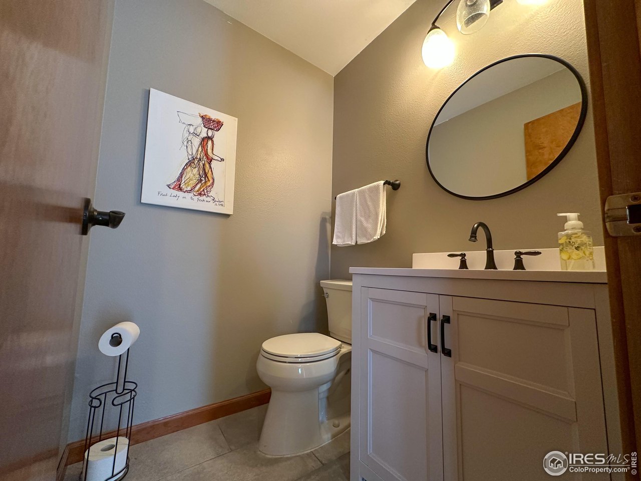 4491 Wellington Road Boulder, CO 80301 - Photo 9 of 40 a bathroom with a sink mirror and toilet