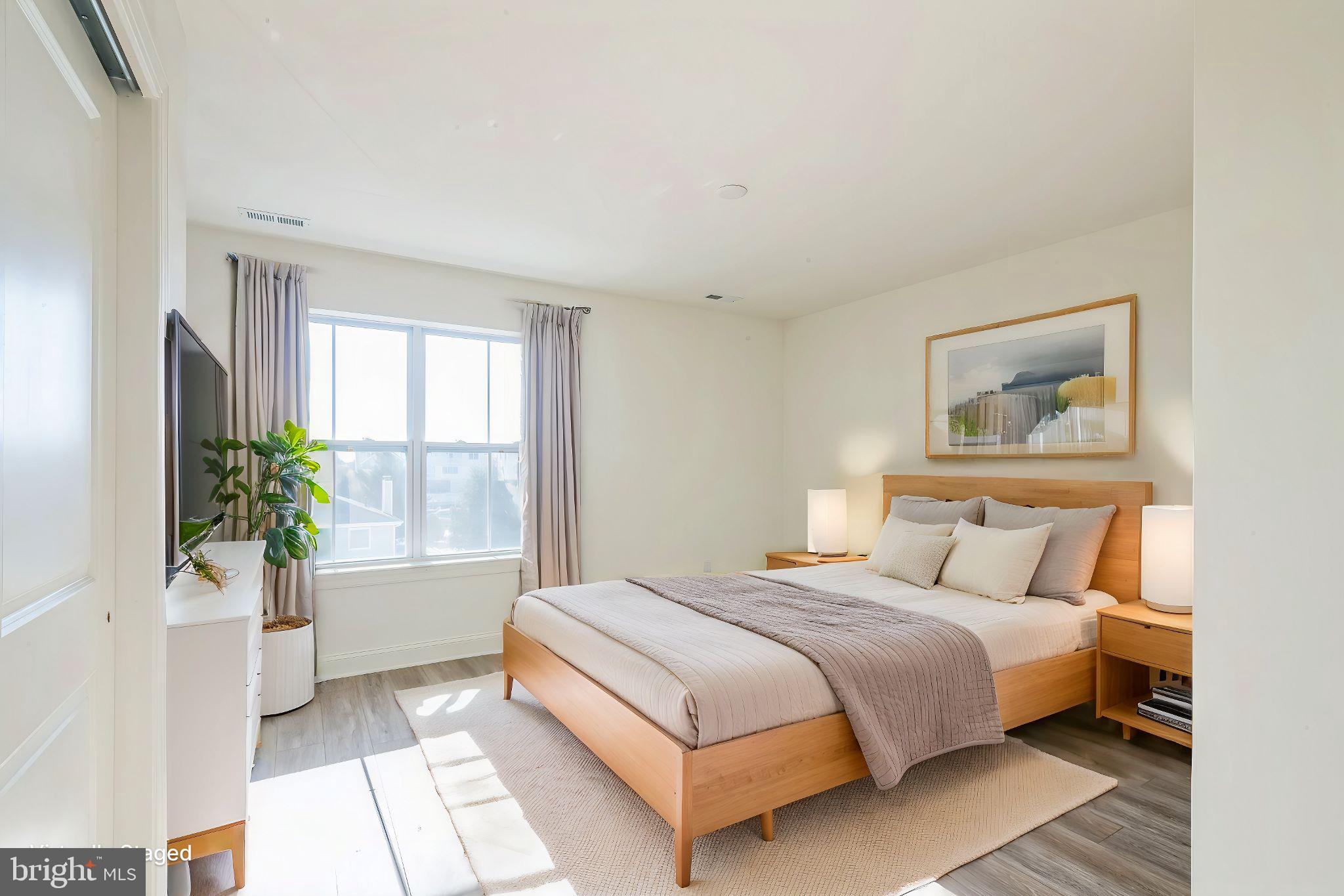 133 A Woosamonsa Road Pennington, NJ 08534 - Photo 13 of 25 a bedroom with a bed lamp and a potted plant