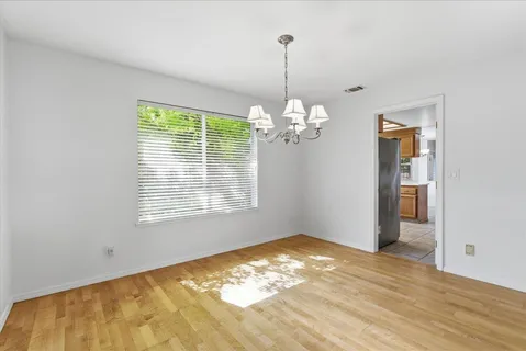 a kitchen with stainless steel appliances granite countertop a refrigerator and a stove