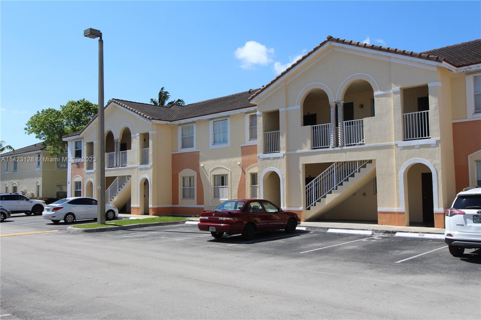1652 Southeast 28th Street, Unit 105 Homestead, FL 33035 - Photo 15 of 18 a view of a car park in front of house