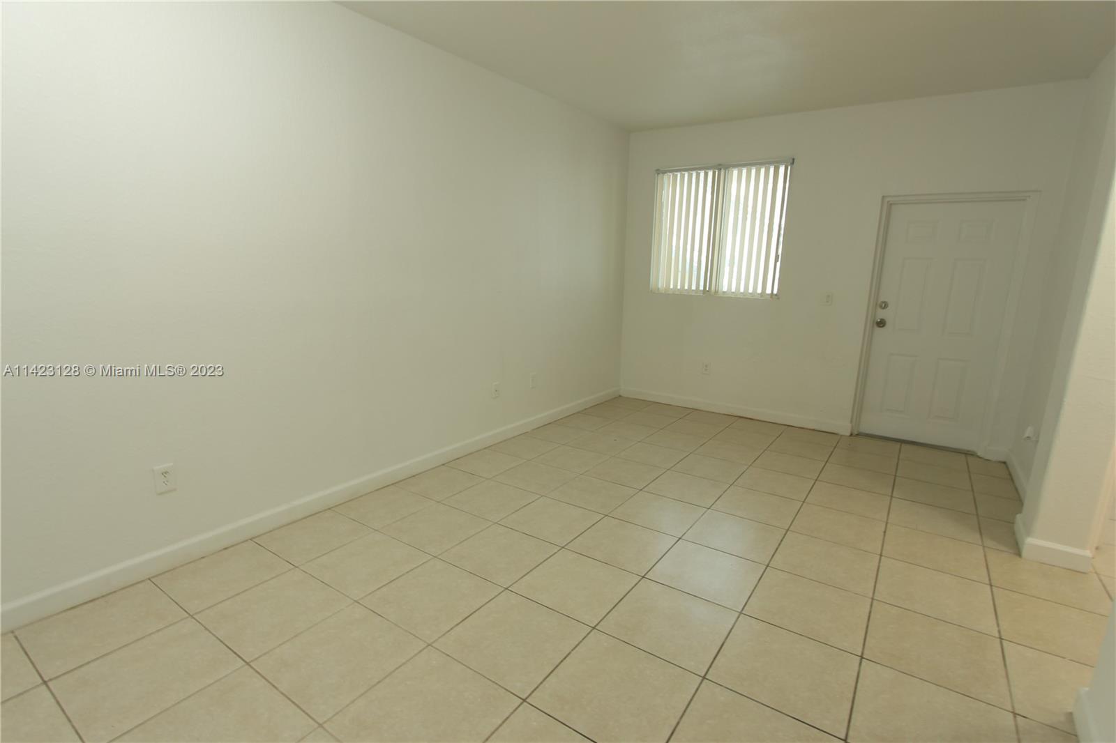 1652 Southeast 28th Street, Unit 105 Homestead, FL 33035 - Photo 2 of 18 an empty room with windows