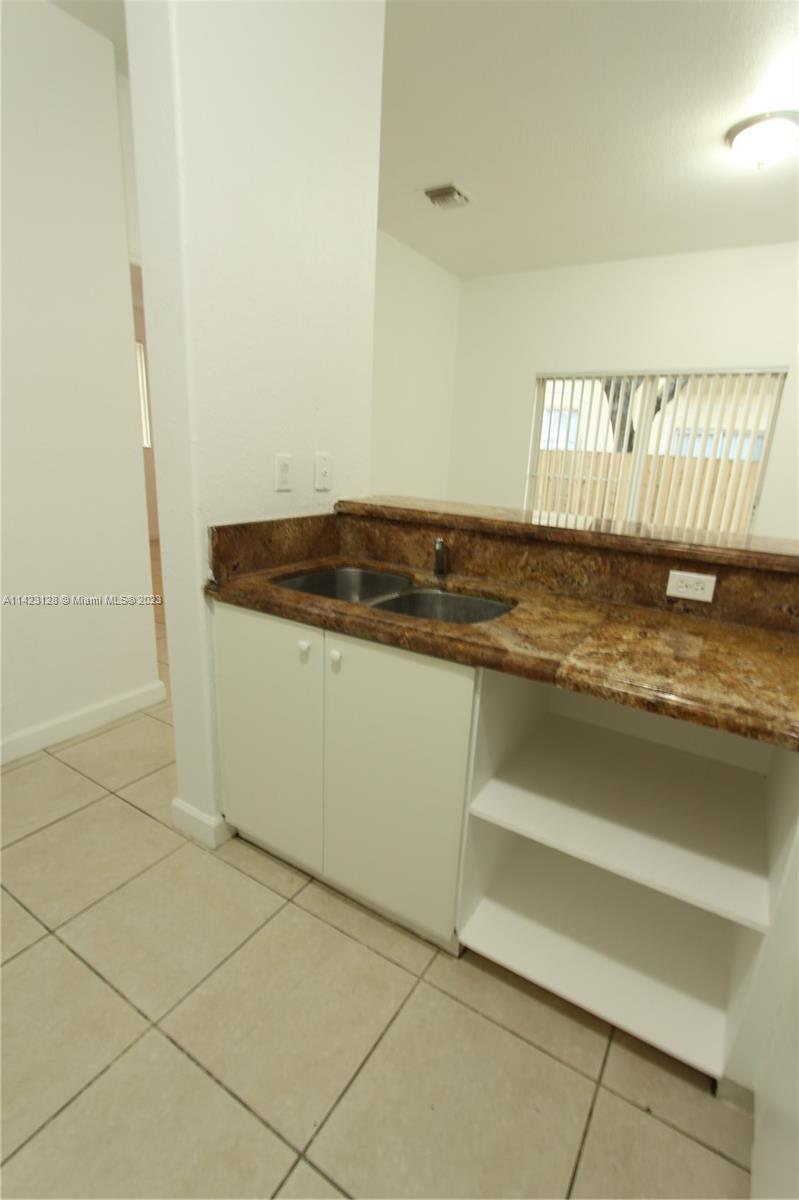 1652 Southeast 28th Street, Unit 105 Homestead, FL 33035 - Photo 6 of 18 a view of a kitchen