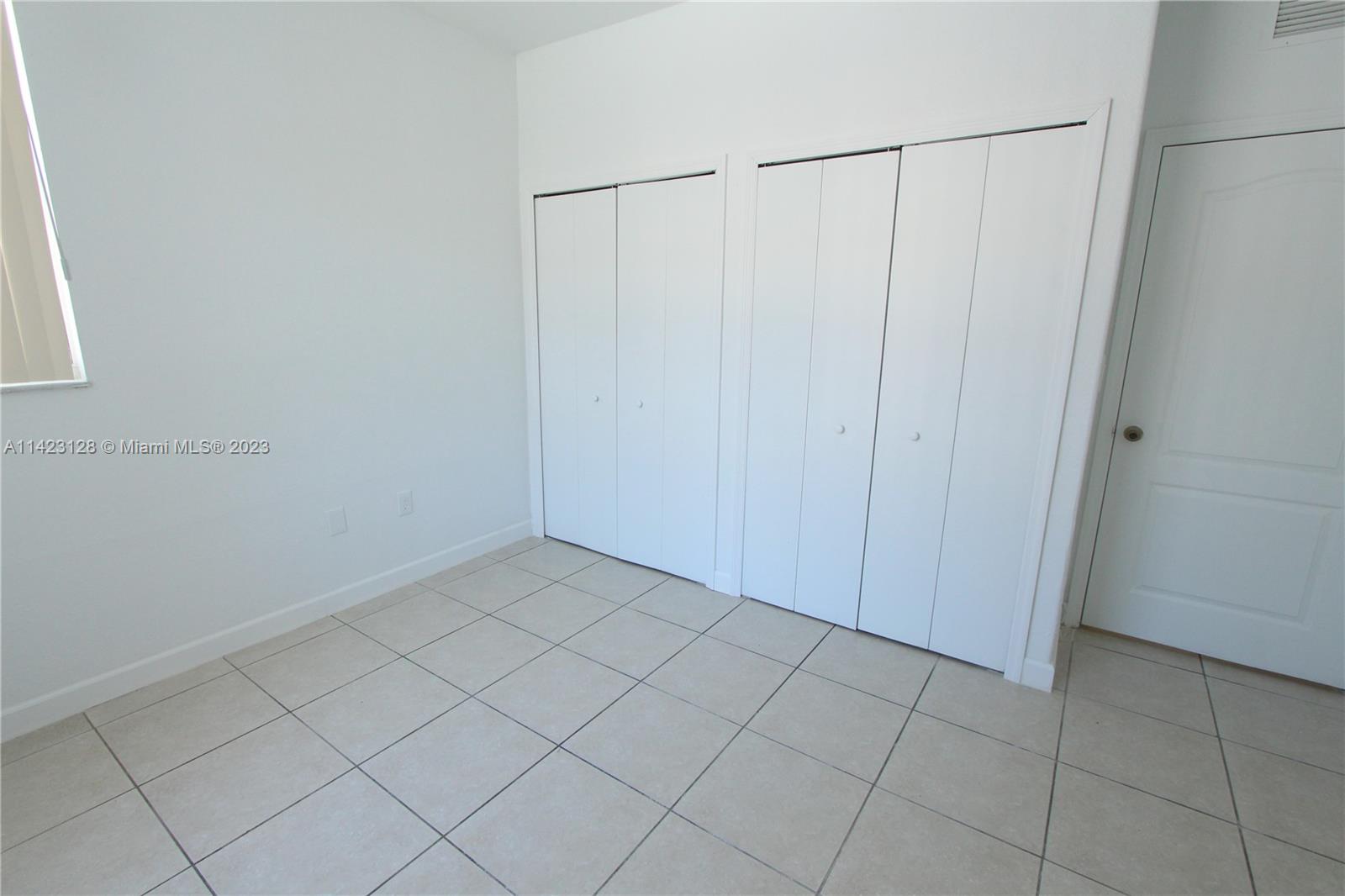 1652 Southeast 28th Street, Unit 105 Homestead, FL 33035 - Photo 8 of 18 a view of a closet