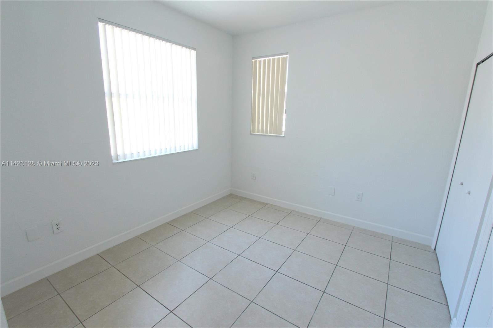 1652 Southeast 28th Street, Unit 105 Homestead, FL 33035 - Photo 10 of 18 an empty room with a window