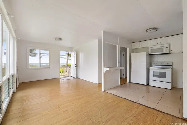 a view of a kitchen with wooden floor and electronic appliances
